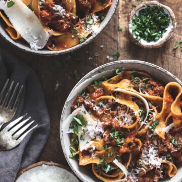 Two bowls of pappardelle bolognese