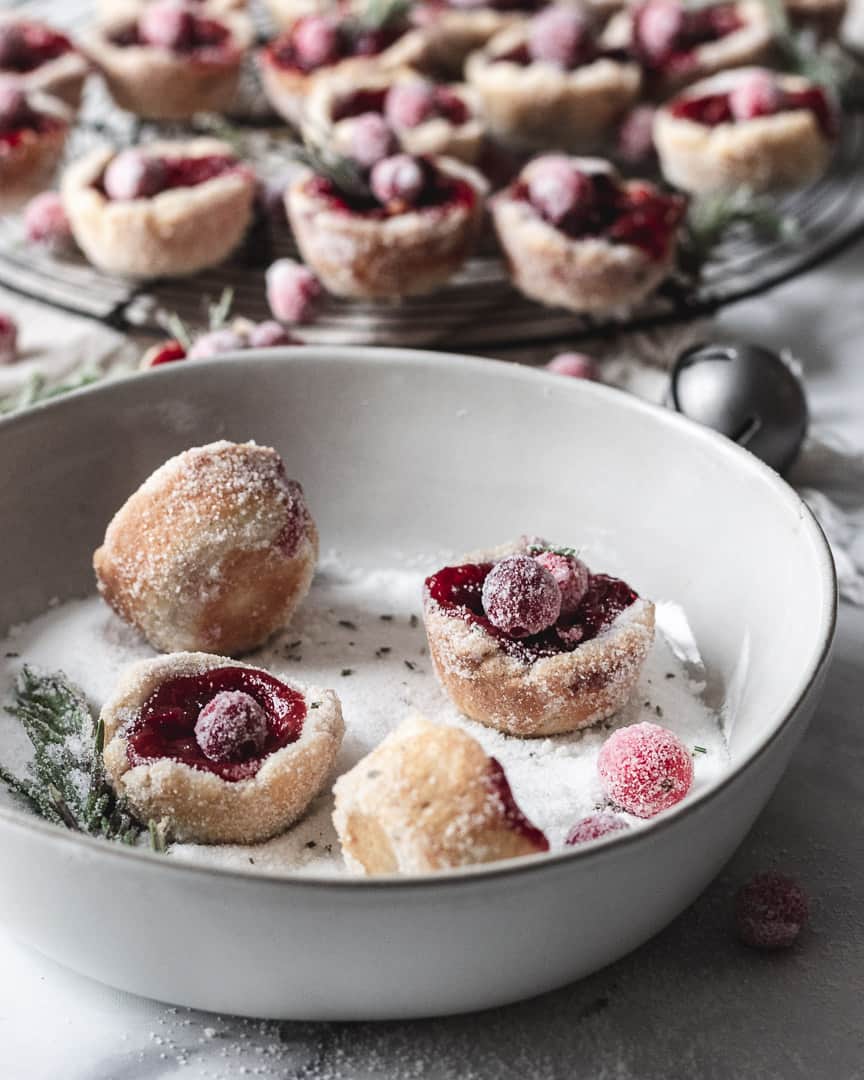 cranberry tassies in bowl with rosemary sugar