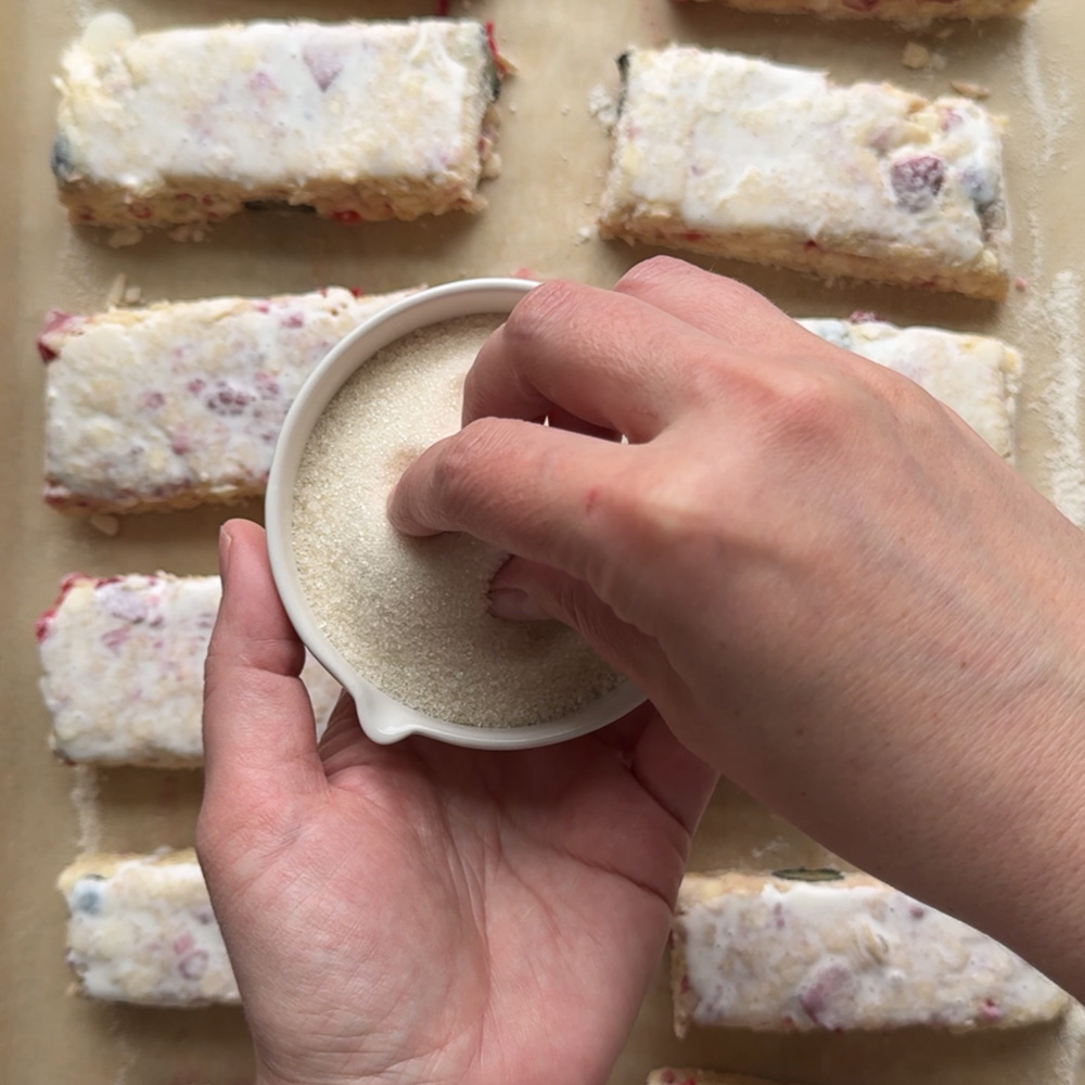 scones being sprinkled with sugar before baking