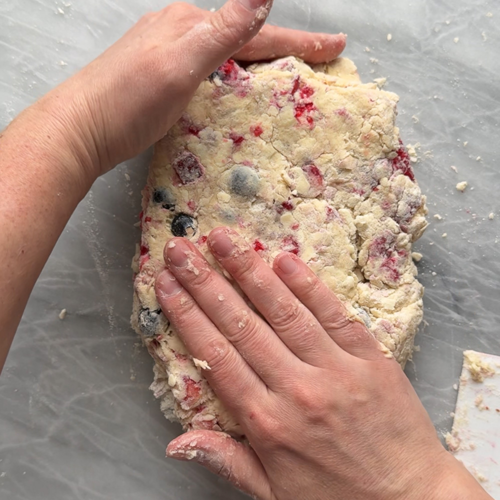 hands pressing dough into a rectangle