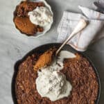 pumpkin crisp in skillet with small serving dish