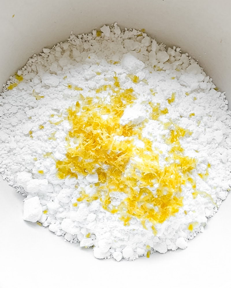 scone glaze process shot - powdered sugar and lemon zest in bowl.