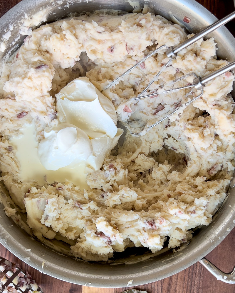 sour cream added to potatoes whipped with hand mixer 