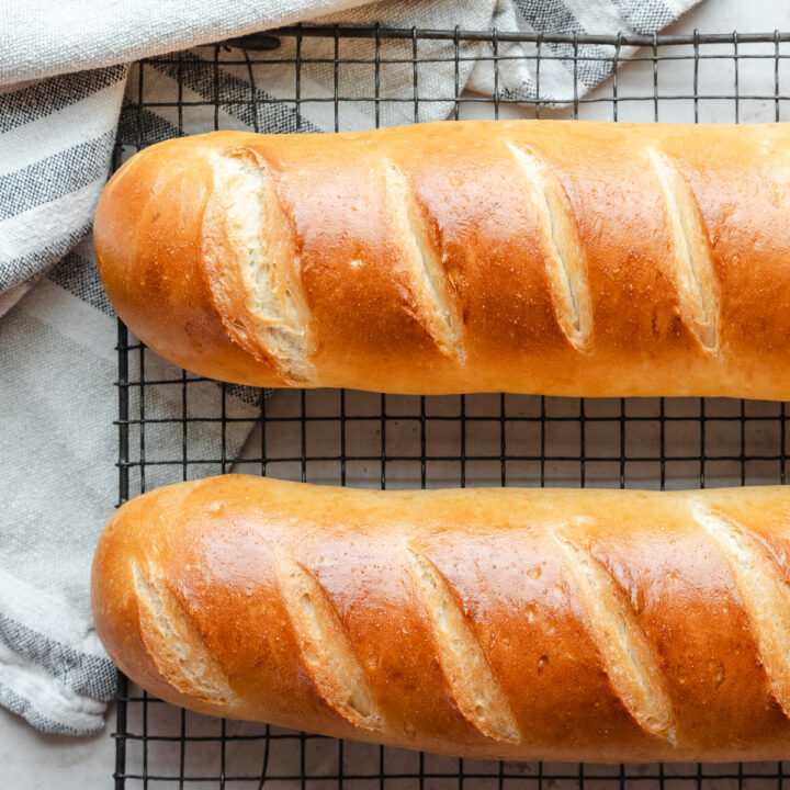two loaves of soft french bread on cooling rack