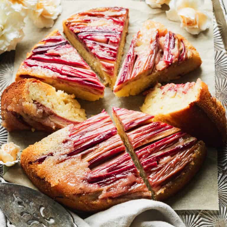 sliced rhubarb upside-down cake on parchment lined baking sheet