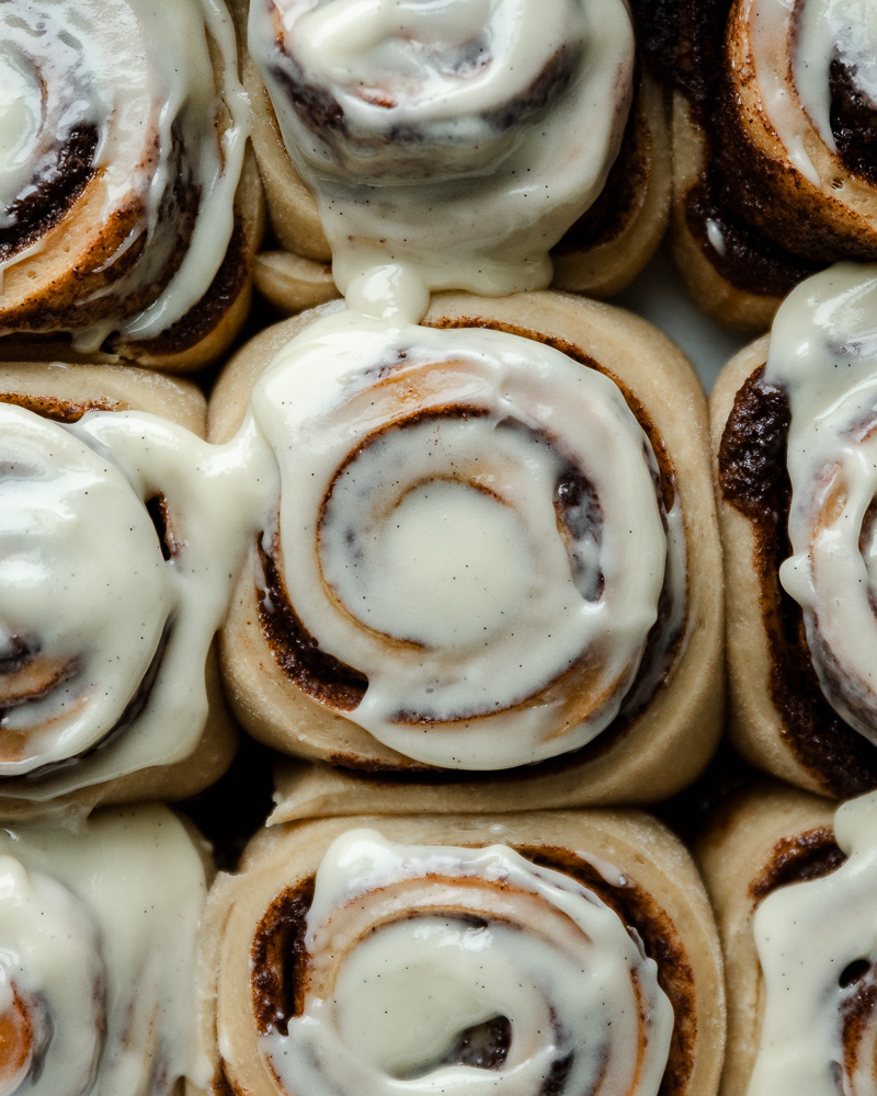 overhead view of frosted sourdough cinnamon rolls