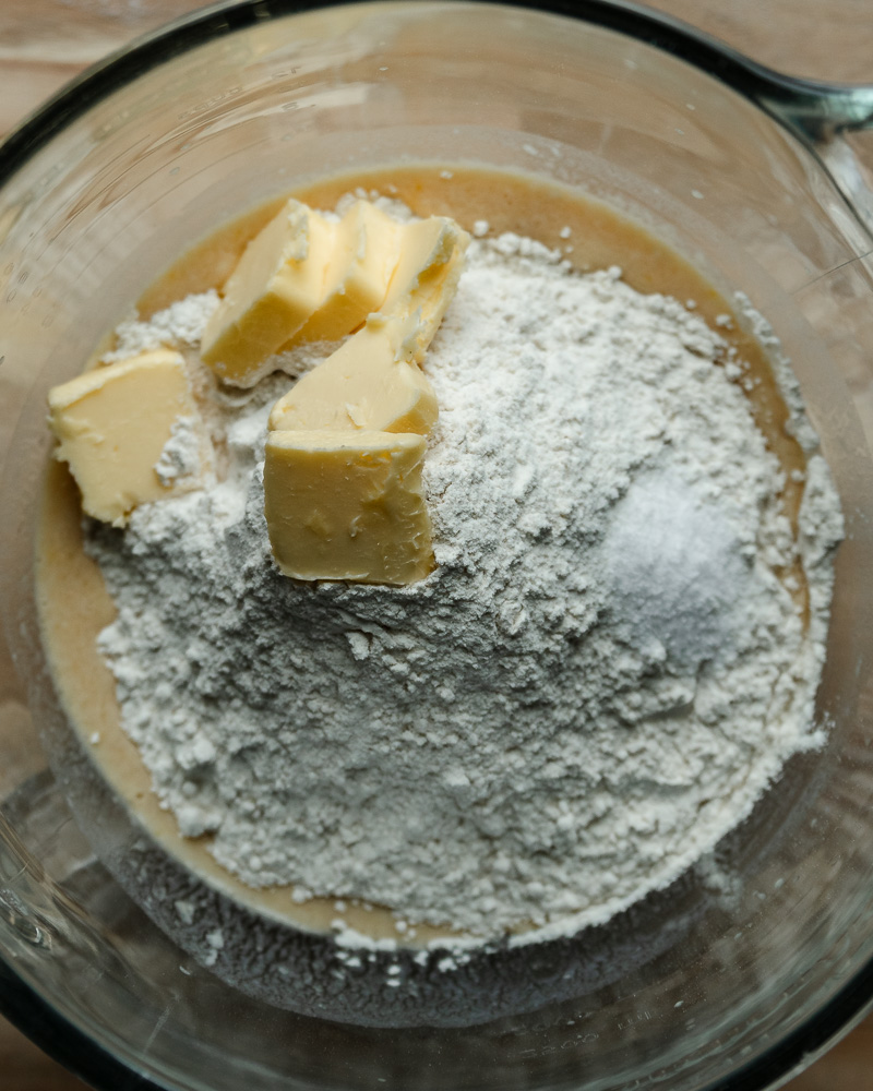 flour and butter added to wet mixture in mixing bowl