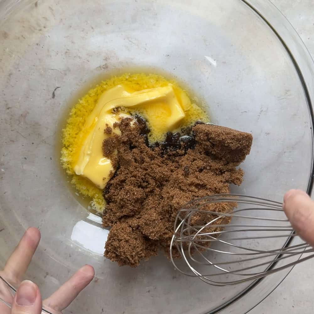 brown sugar and melted butter in glass bowl with whisk