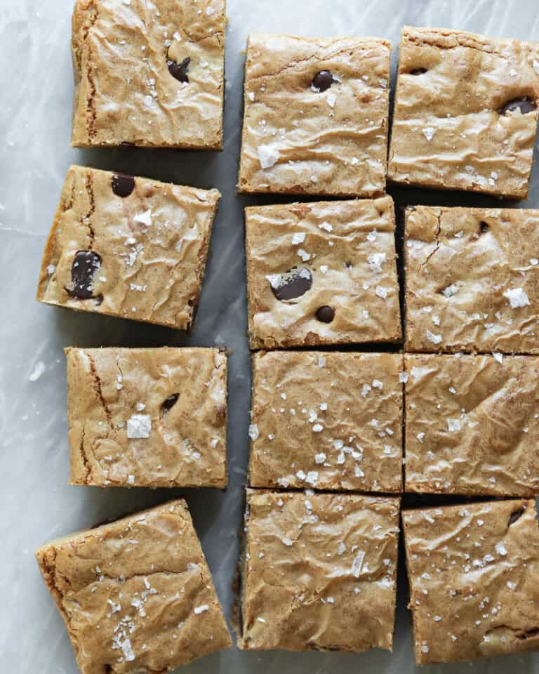 blondies cut into small squares and sprinkled with sea salt on white marble surface