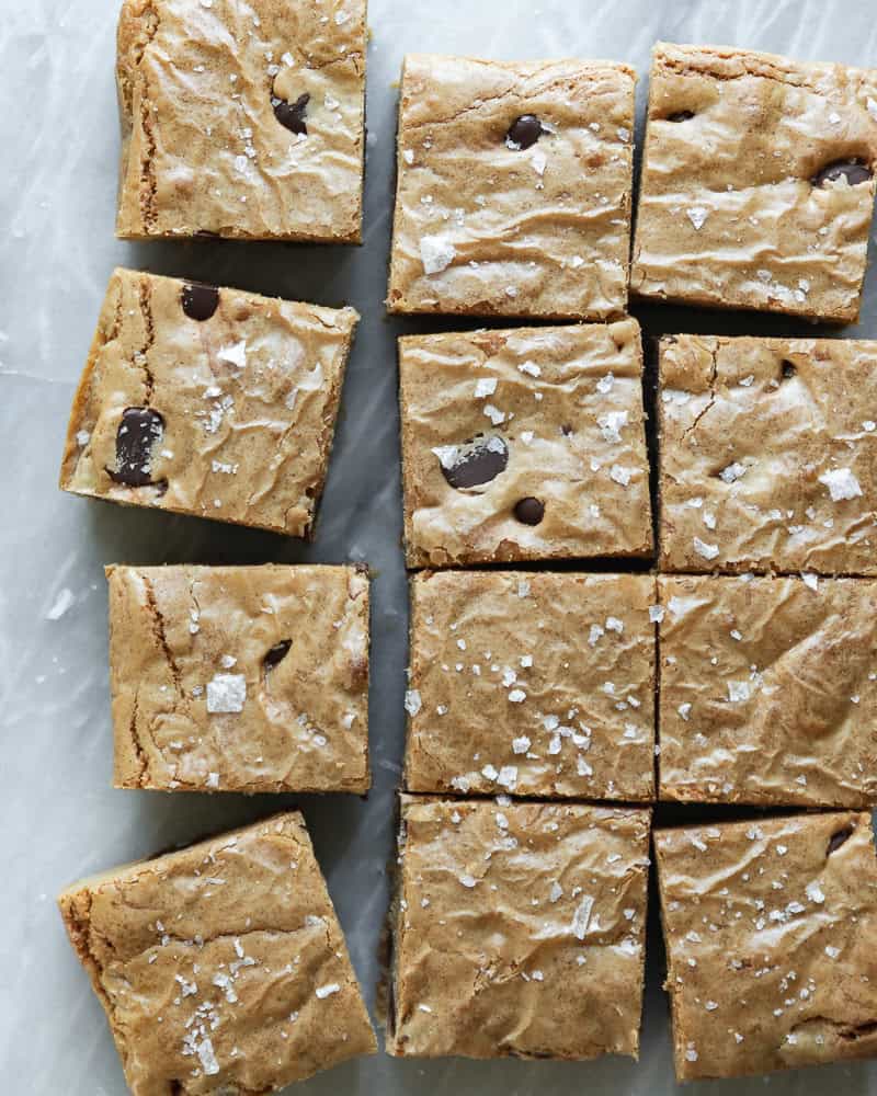 blondies cut into small squares and sprinkled with sea salt on white marble surface