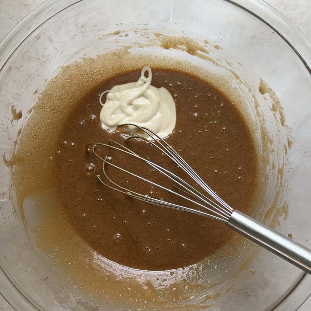 sourdough discard added to wet batter mixture in large glass bowl