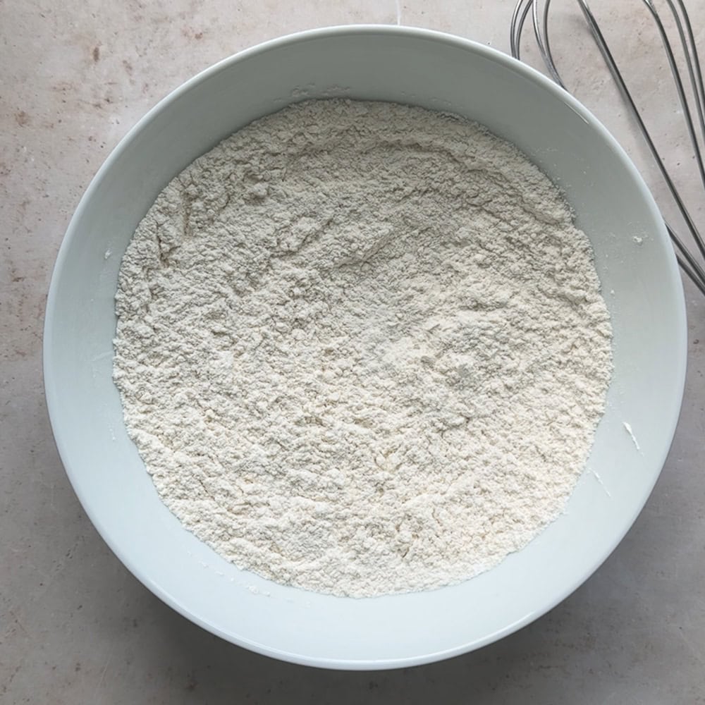 a bowl containing dry ingredients for waffle batter