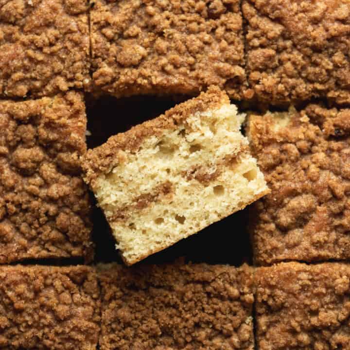 A pan of coffee cake with one slice on its side