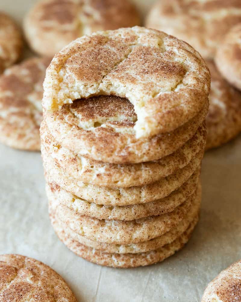 a stack of cookies with one bite taken out of the top cookie