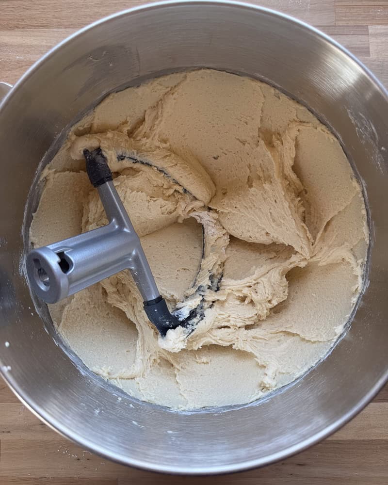 final snickerdoodle cookie dough mixed together in metal mixing bowl