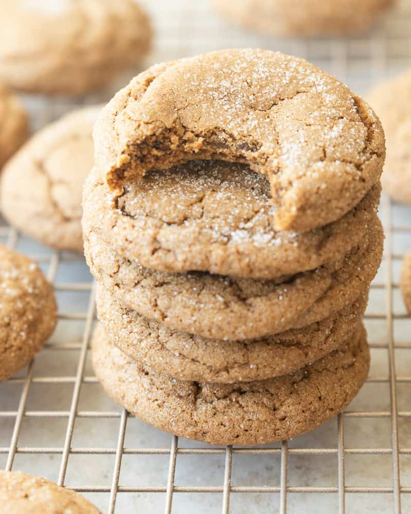 a stack of cookies with one bite taken out of the top cookie
