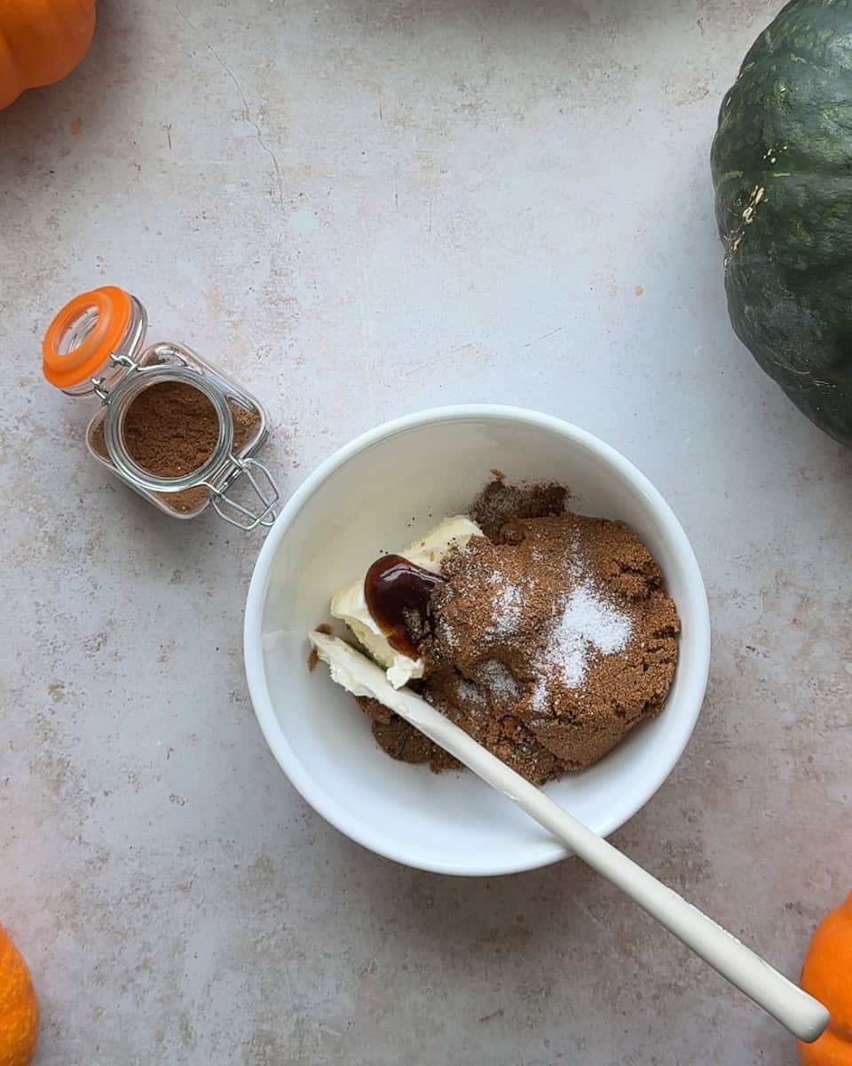 a small white bowl full of cinnamon roll filling ingredients before mixing