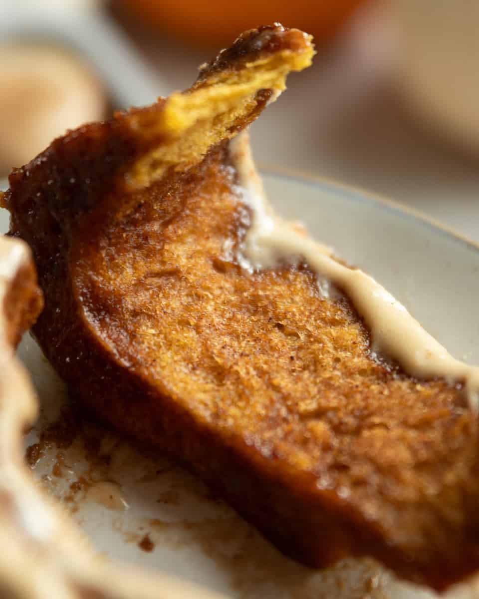 a strip of unraveled cinnamon roll on a small plate
