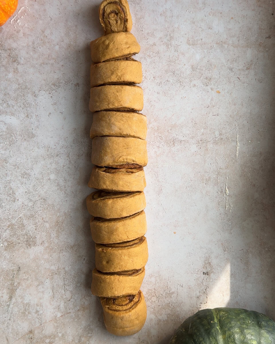 log of cinnamon roll dough cut into 12 pieces