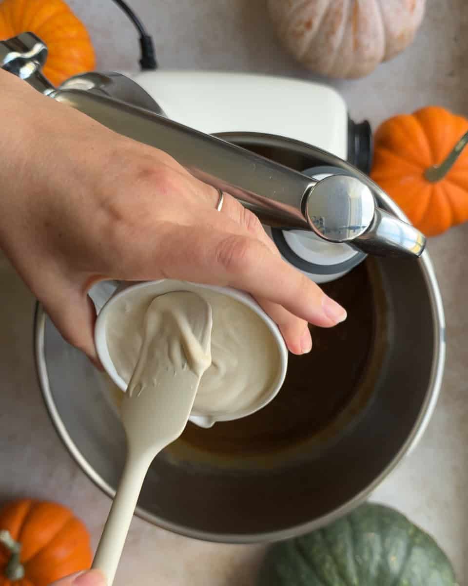 sourdough discard being added to mixing bowl