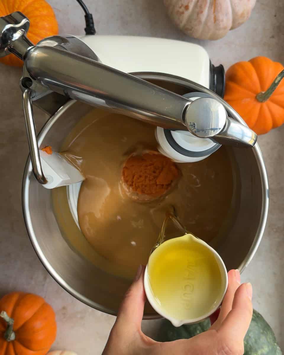 oil being poured into mixer bowl
