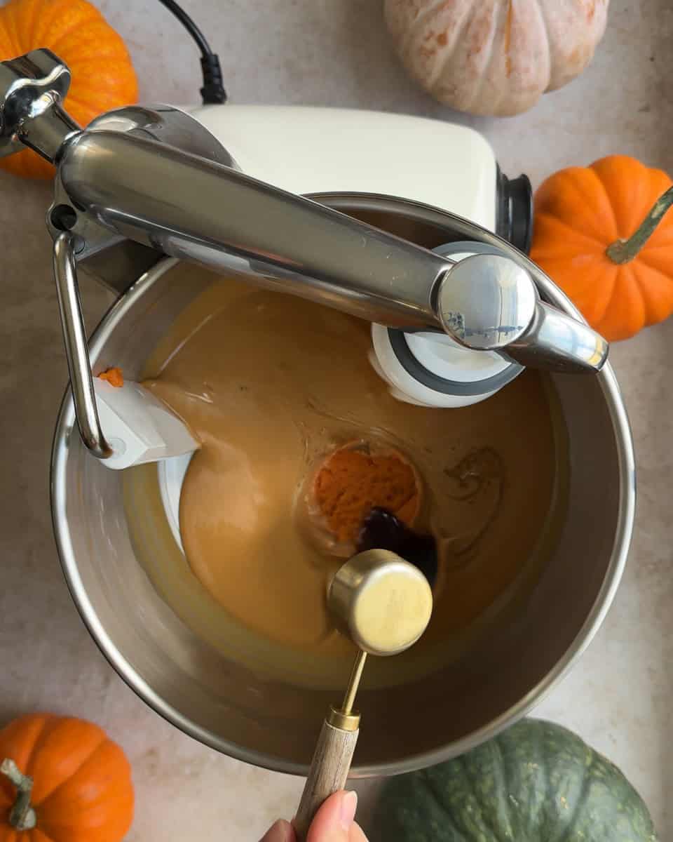 vanilla bean paste being added to mixing bowl