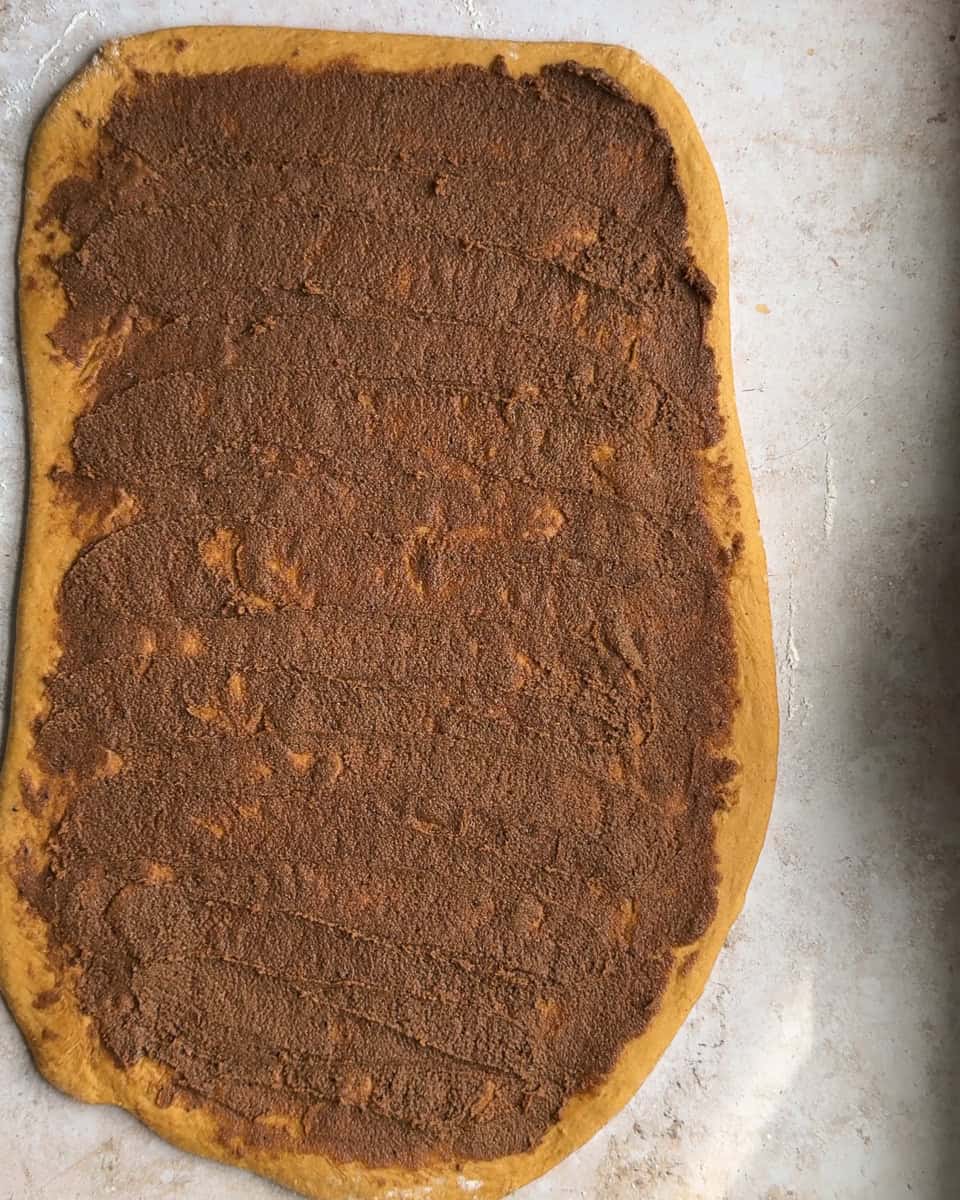 dough rolled out to large rectangle and spread with cinnamon roll filling